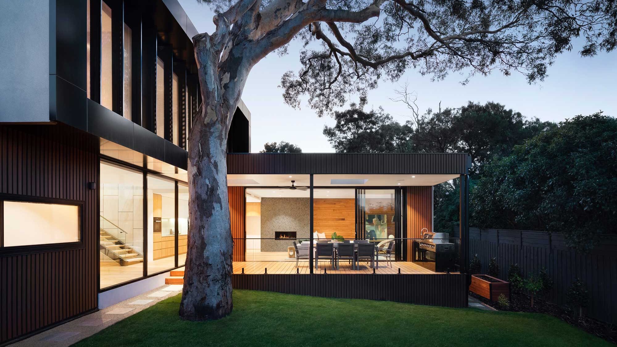 Sleek modern home showcasing roofing & repairs by Klindworth Roofing, The Woodlands Texas specialists, with a clear evening sky.